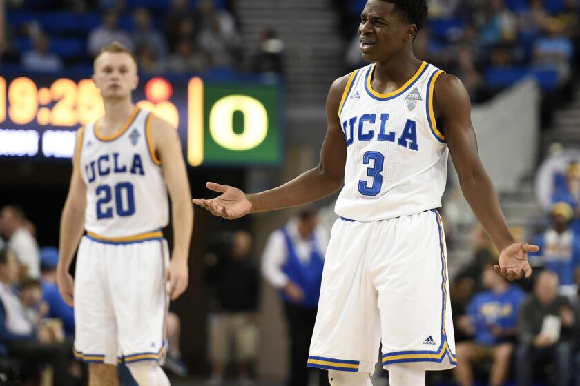 UCLA guard Aaron Holiday (3) reacts to a foul as guard Bryce Alford (20) watches during the second half.