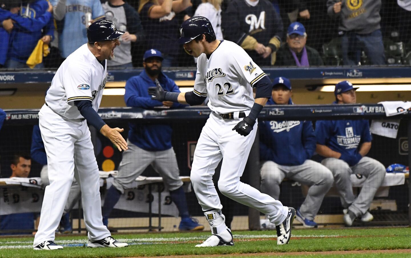 With the Dodgers looking on, Milwaukee Brewers Christian Yelich celebrates after hitting a solo homerun in the first inning.