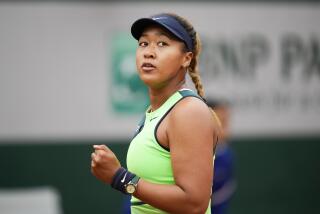 Japan's Naomi Osaka clenches her fist after scoring a point against Amanda Anisimova of the U.S. during their first round match at the French Open tennis tournament in Roland Garros stadium in Paris, France, Monday, May 23, 2022. (AP Photo/Christophe Ena)