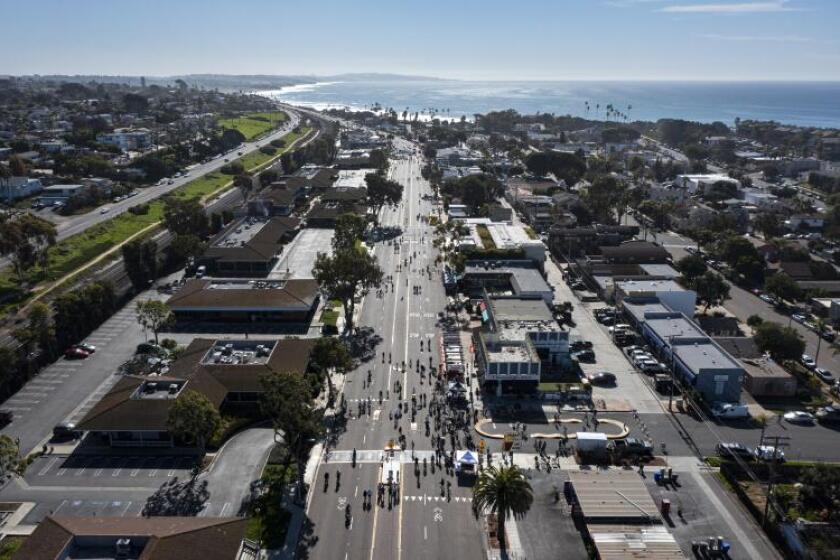 Bicyclists pass homes and business in Encinitas in January.