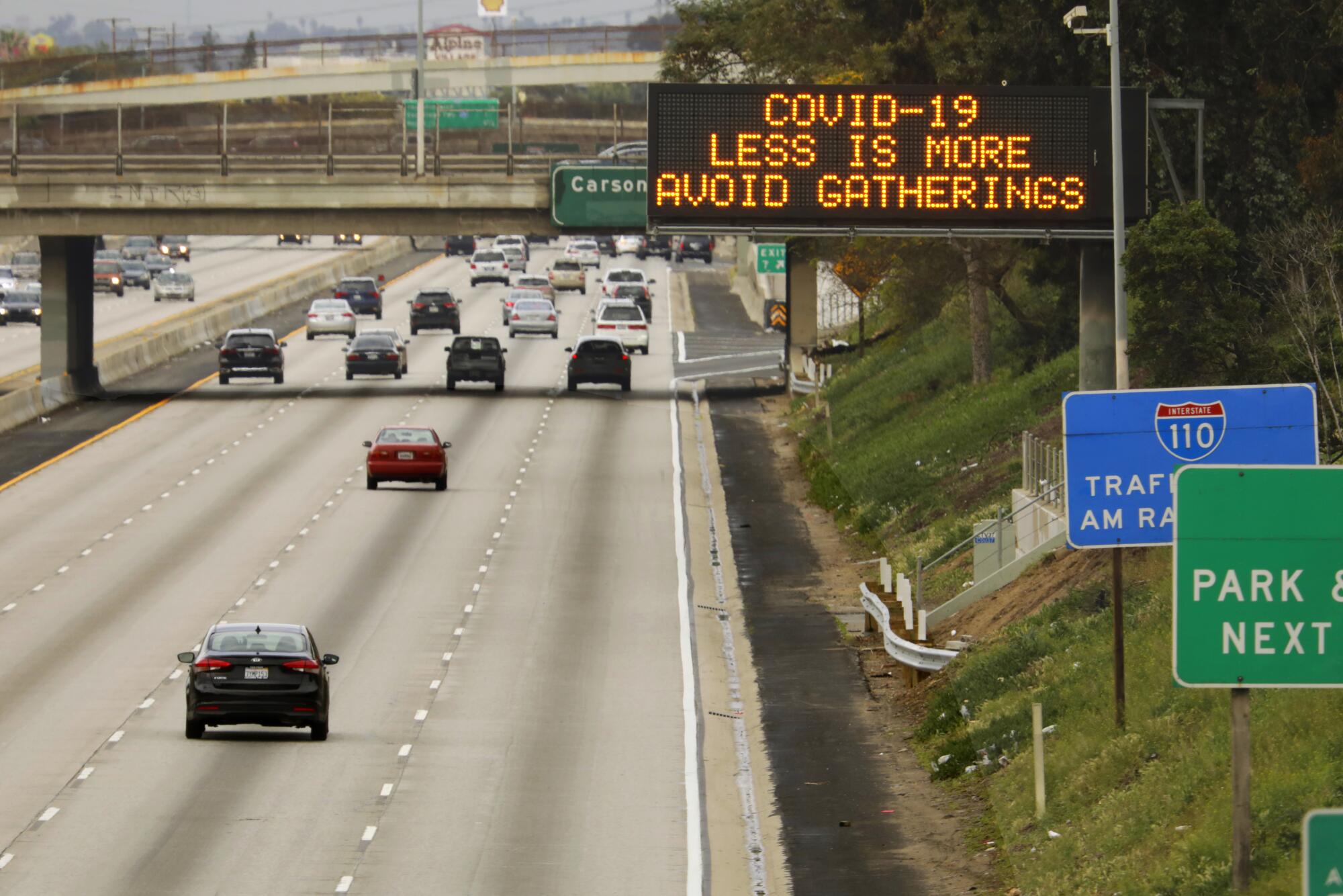 Signs on L.A. freeways encourage motorists to practice social distancing.