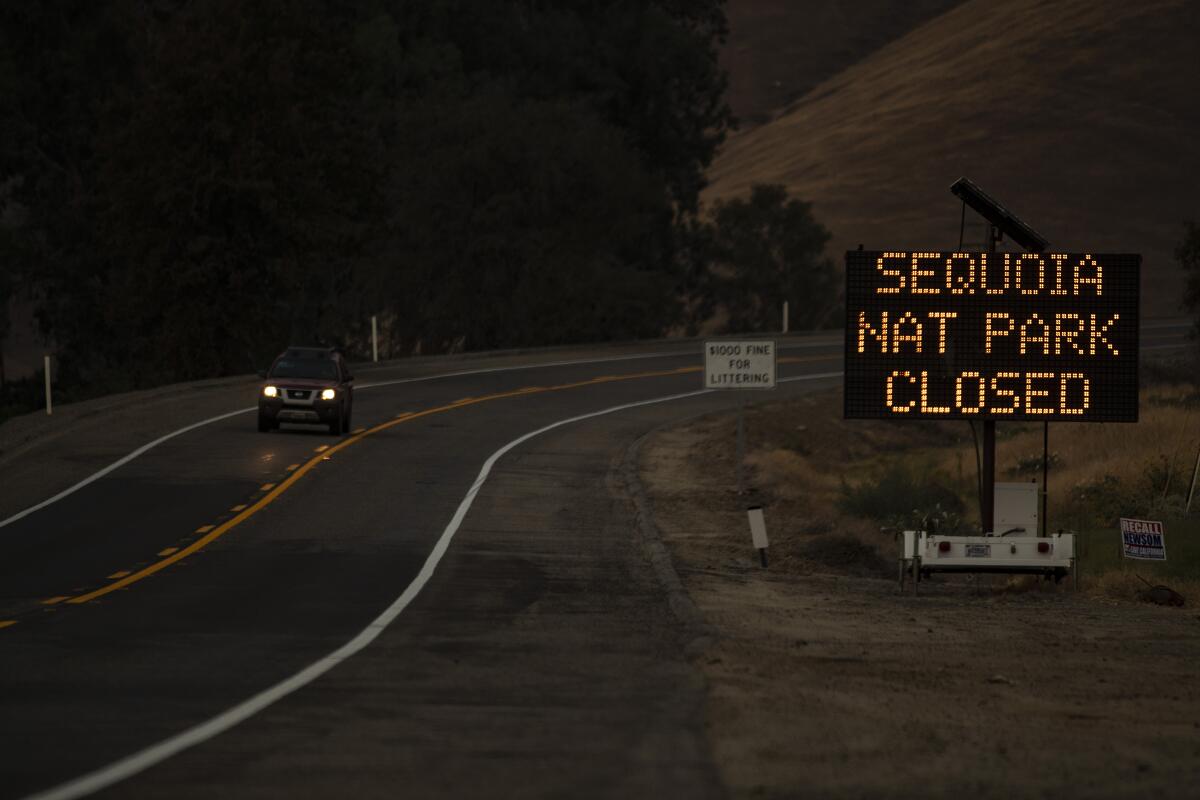 A digital sign by the roadside says Sequoia Nat Park Closed