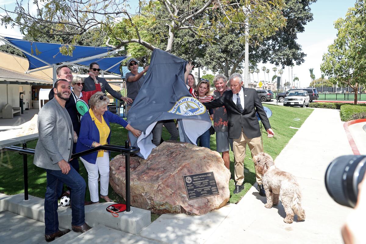 Newport Beach elected officials and parks commissioners unveil a plaque.