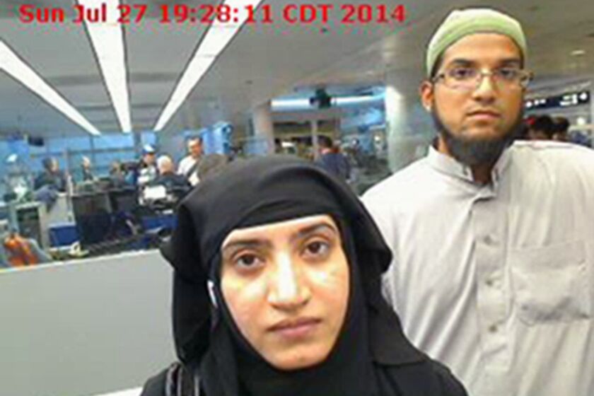 This July 27, 2014, file photo provided by U.S. Customs and Border Protection shows Tashfeen Malik, left, and Syed Rizwan Farook, as they passed through O'Hare International Airport in Chicago.