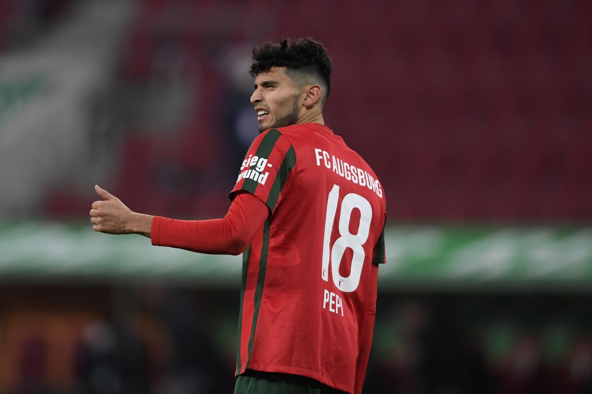 Augsburg's Ricardo Pepi reacts during the German Bundesliga soccer match between Eintracht Frankfurt and FC Augsburg at the WWK Arena in Augsburg, Germany, Sunday, Jan. 16, 2022. (AP Photo/Andreas Schaad)