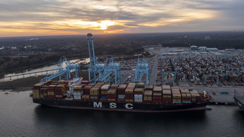 FILE - The sun sets behind The Mediterranean Shipping Company ship MSC Meline, front, which is in the process of being loaded at the Virginia International Gateway Marine terminal Wednesday Dec 1, 2021, in Norfolk, Va. For many, supply chain issues mean that you didn’t get your kid the exact toy they wanted or that your favorite spice isn’t in stock at the grocery store. On the surface, some might think the hotel industry is immune to supply chain concerns. (AP Photo/Steve Helber, File)