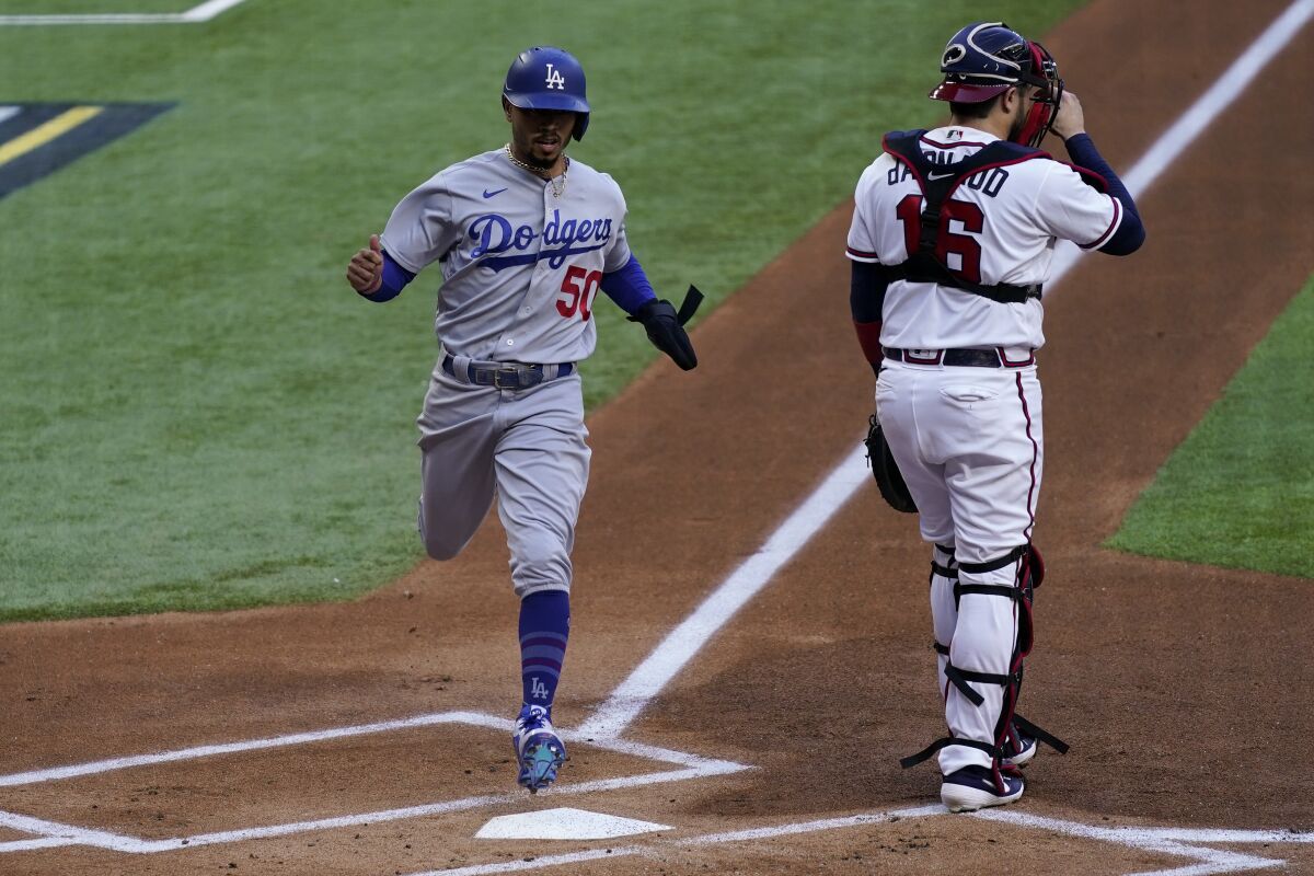 Dodgers baserunner Mookie Betts scores past Atlanta Braves catcher Travis d'Arnaud.