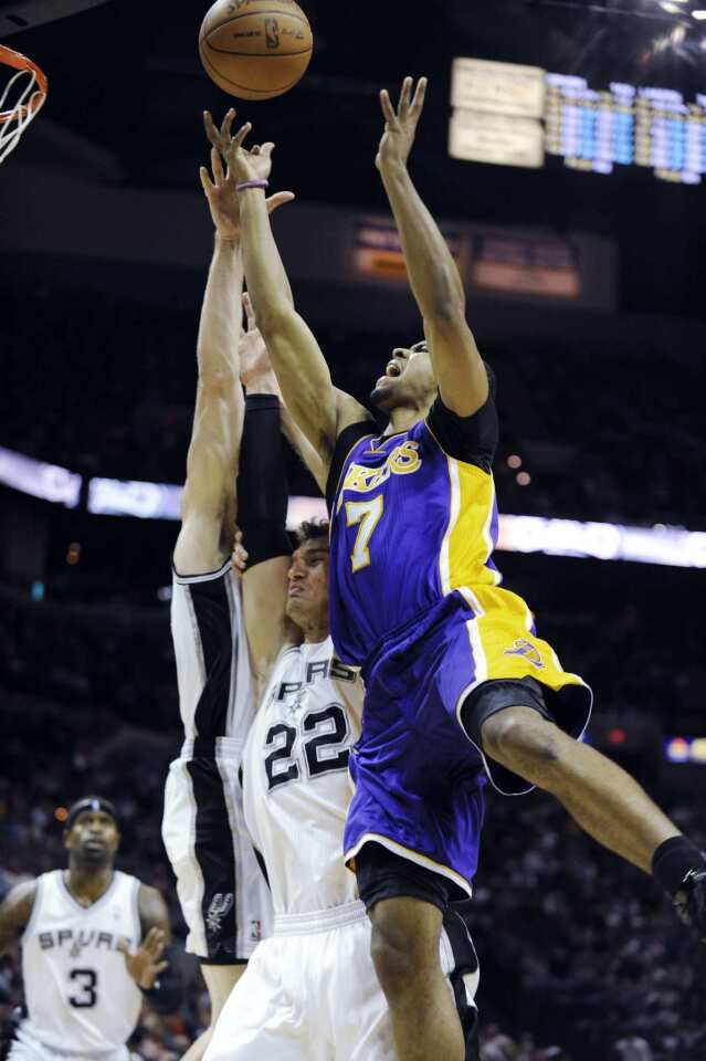 Lakers point guard Ramon Sessions is fouled by Spurs center Tiago Splitter (22) on a drive in the second half Friday night in San Antonio.