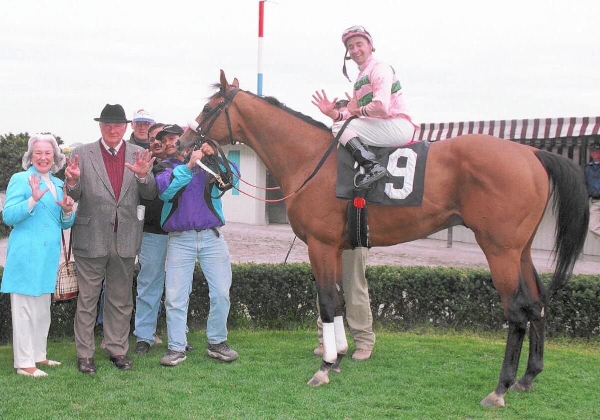 Hall of Fame racehorse trainer Allen Jerkens, second from left, exults after Notoriety (9), ridden by Joe Bravo, captures a win at Aqueduct Racetrack on his 70th birthday: April 21, 1999.