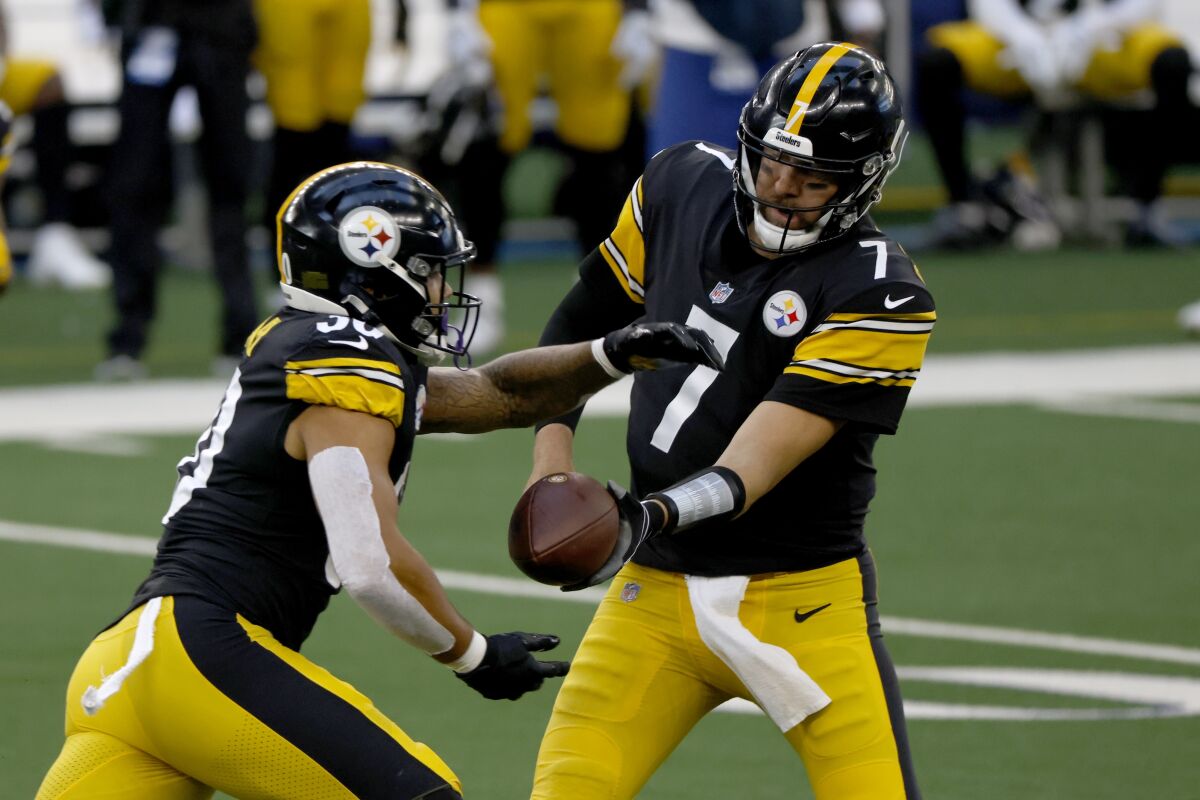 Pittsburgh Steelers running back James Conner (30) takes the hand off from quarterback Ben Roethlisberger (7) in the first half of an NFL football game against the Dallas Cowboys in Arlington, Texas, Sunday, Nov. 8, 2020. (AP Photo/Ron Jenkins)