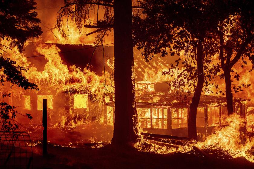Flames from the Dixie Fire consume a home in the Indian Falls community of Plumas County, Calif., Saturday, July 24, 2021. The fire destroyed multiple residences as it tore through the area. (AP Photo/Noah Berger)