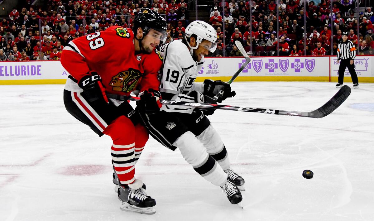 KKings left wing Alex Iafallo (19) tries to fend off Blackhawks defenseman Dennis Gilbert in a battle for possession of the puck during the first period on Oct. 27, 2019, in Chicago.