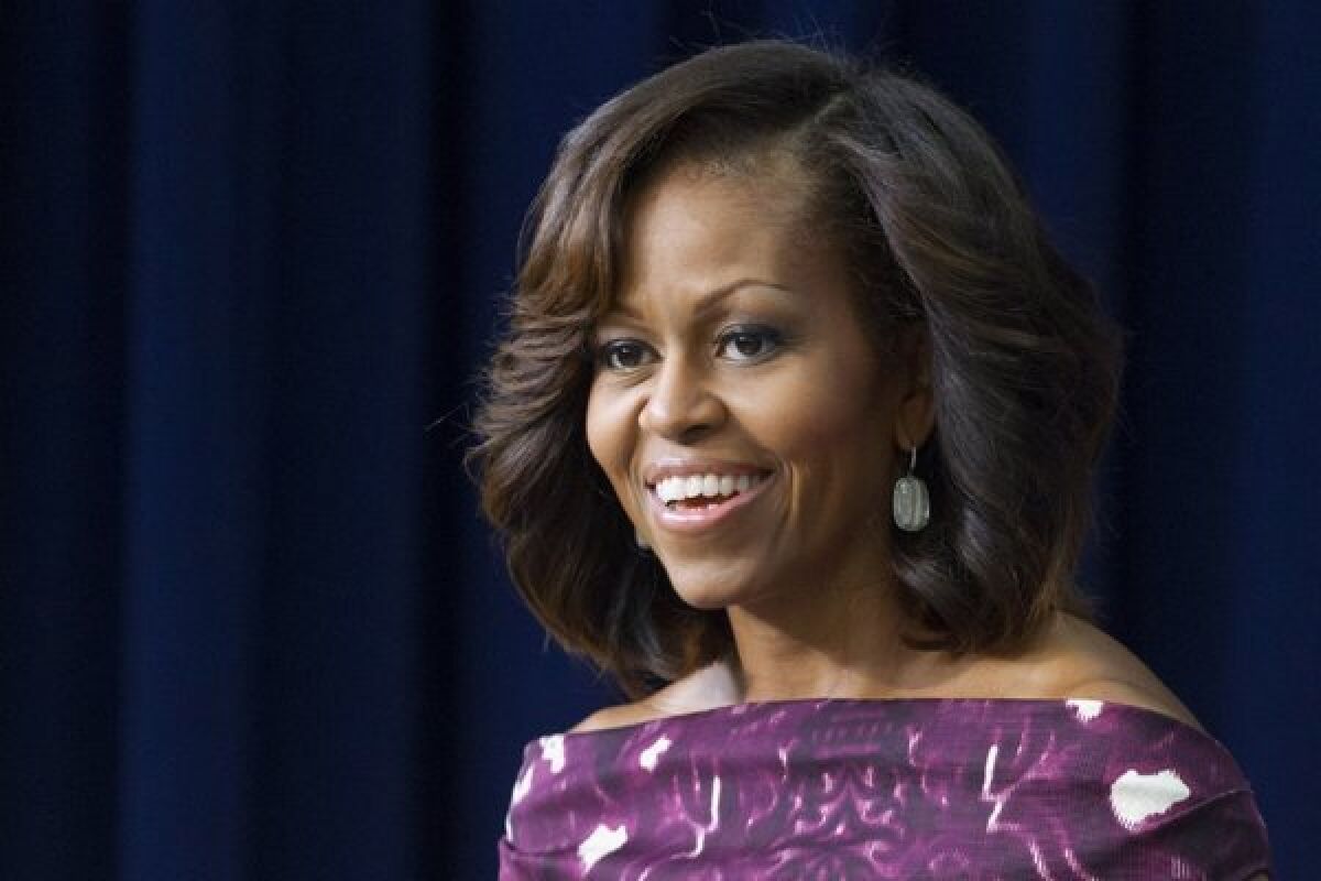 Michelle Obama smiles in a close-up image. 