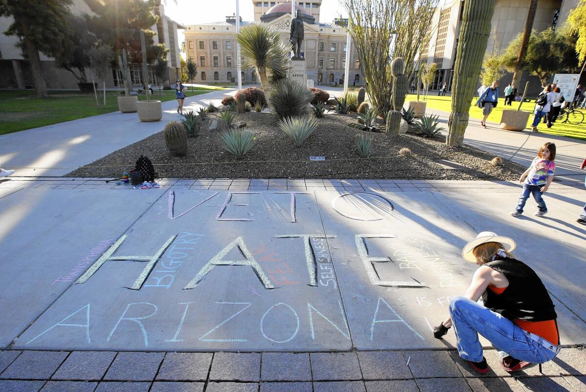 A gay rights supporter delivers a message Friday at the Arizona Capitol in Phoenix.