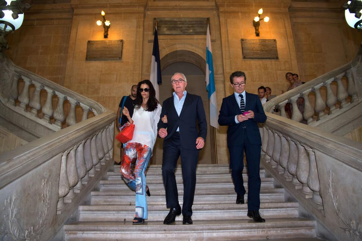 Olympique de Marseille owner Frank McCourt leaves city hall in Marseille, France, with his wife, Monica, and Paris Turf CEO Jacques-Henri Eyraud, right, following a news conference in August 2016.
