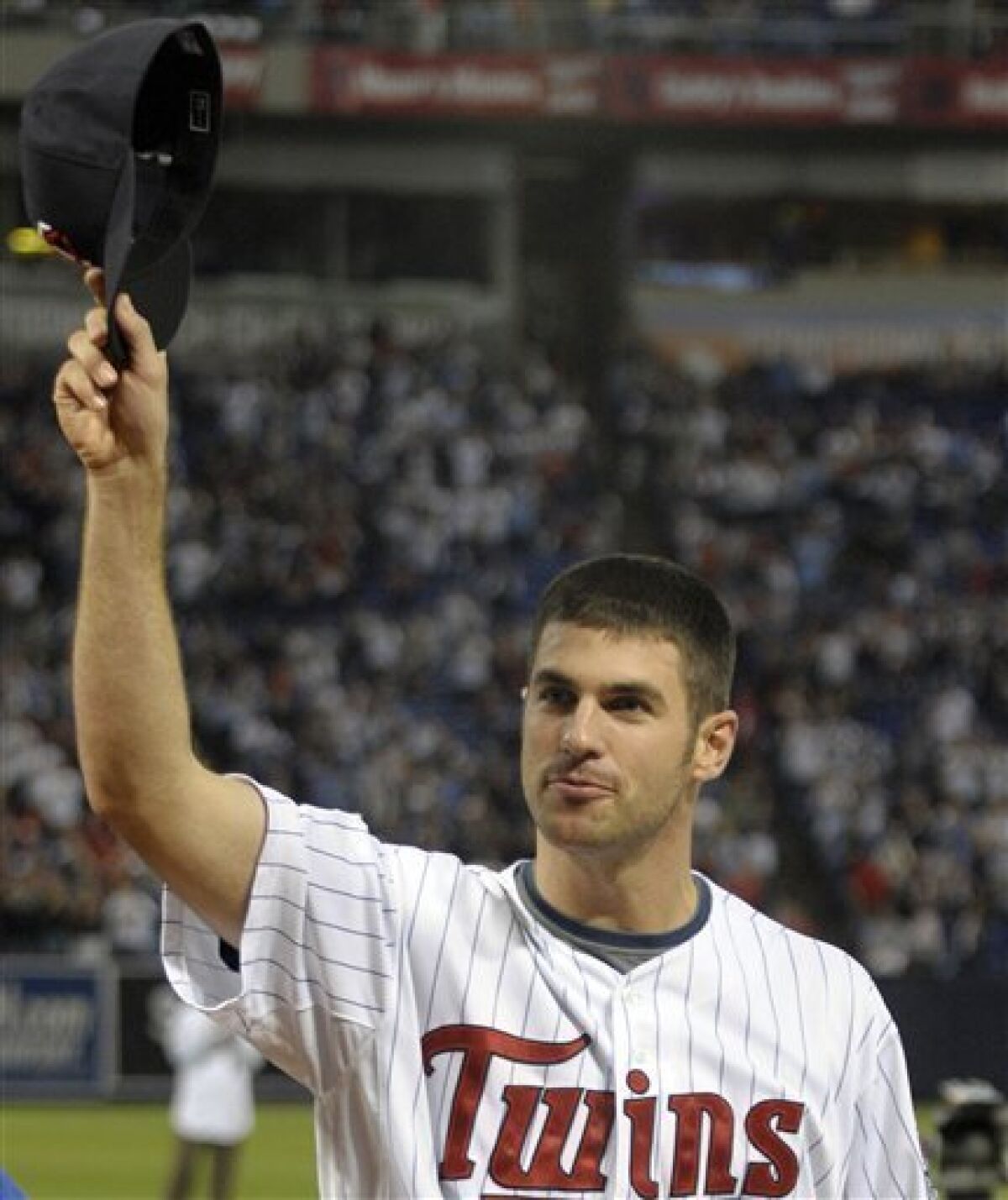 FILE - This is an Oct. 4, 2009, file photo showing Minnesota Twins catcher Joe Mauer acknowledges the crowd before a baseball game, in Minneapolis. Mauer has become only the second catcher in 33 years to win the American League Most Valuable Player Award, Monday, Nov. 23, 2009.(AP Photo/Tom Olmscheid, File)