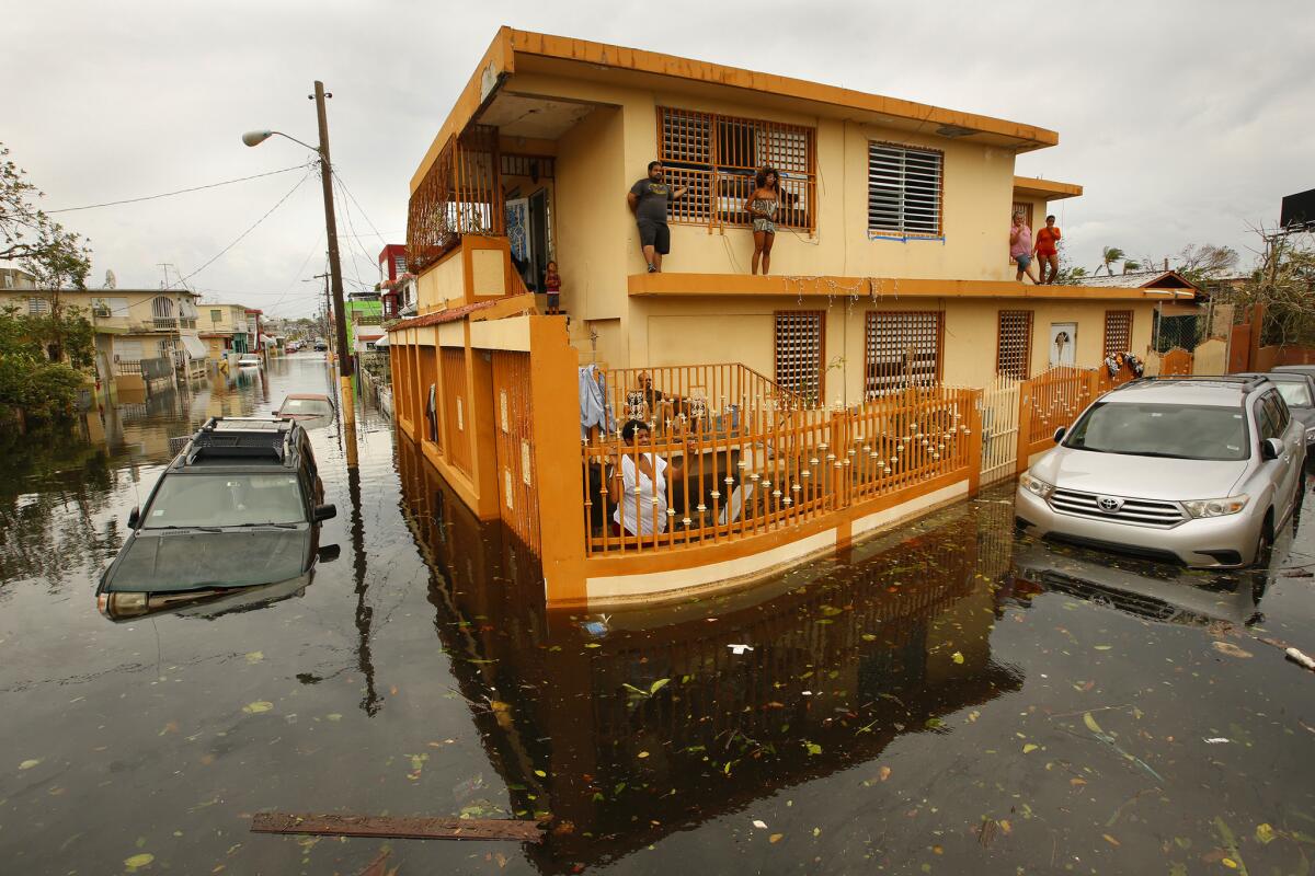 Residents of Isla Palmeras, a neighborhood in San Juan, are surrounded by floodwater.
