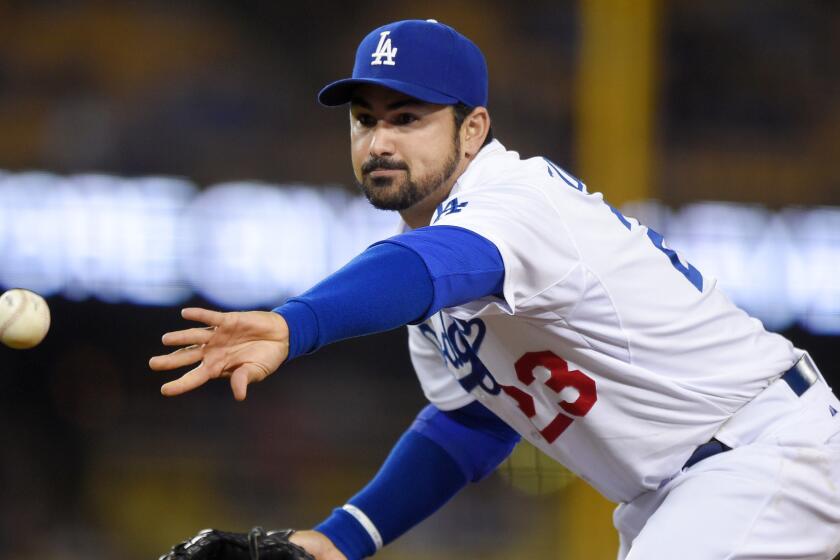 Dodgers first baseman Adrian Gonzalez tosses the ball during a game against the Atlanta Braves on May 26, 2015.
