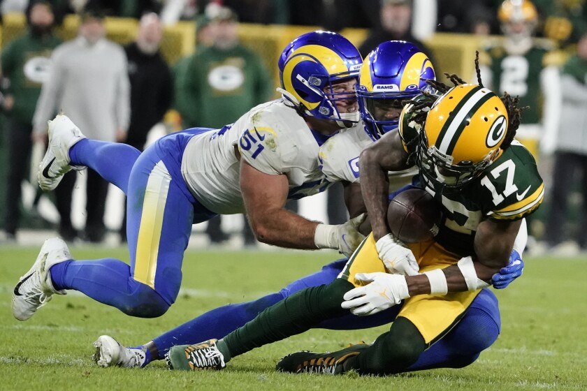 Los Angeles Rams' Troy Reeder and Jalen Ramsey break up a pass intended for Green Bay Packers' Davante Adams during the second half of an NFL football game Sunday, Nov. 28, 2021, in Green Bay, Wis. (AP Photo/Morry Gash)