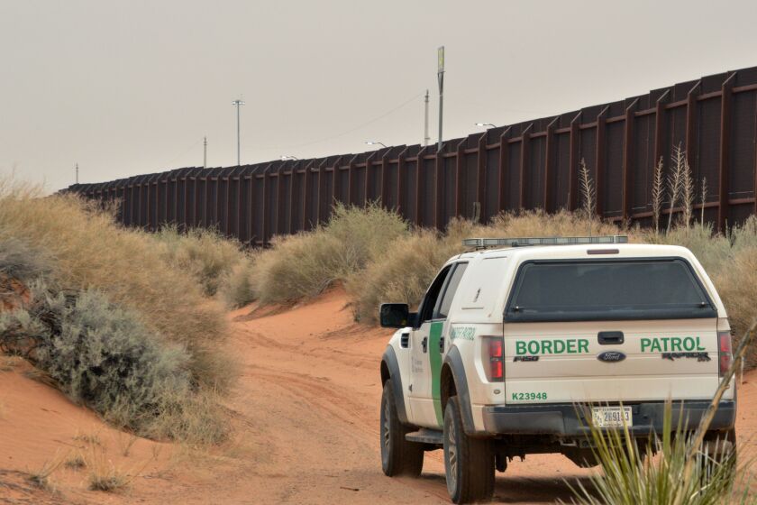 A U.S. Border Patrol agent drives near the U.S.-Mexico border fence in Santa Teresa, N.M.