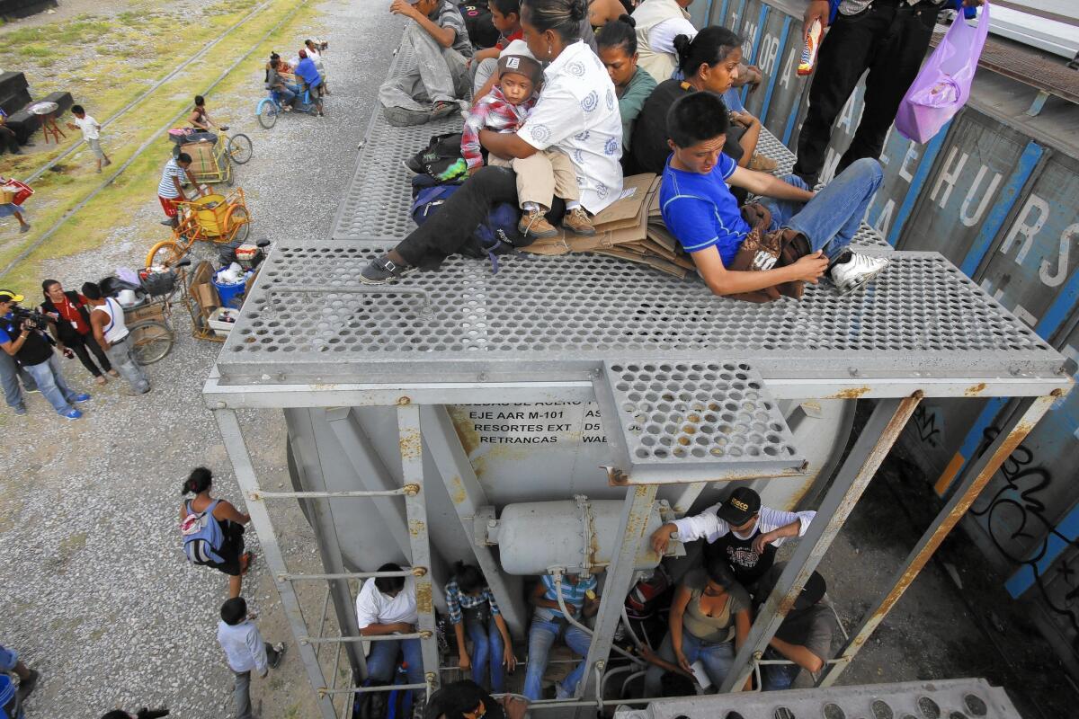 Migrants from Central America sit aboard a train in Arriaga, southern Mexico, on their way north.