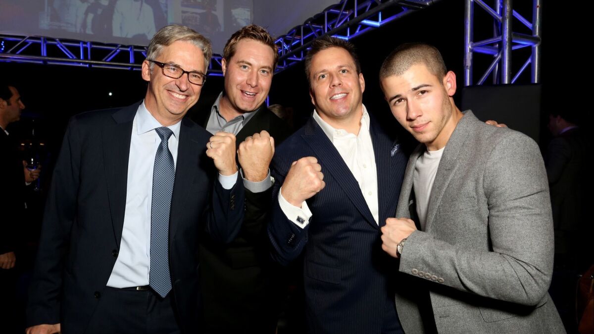 Daniel York, left, shown with AT&T executives Bart Peters and Chris Long, celebrate the season premiere of DirecTV's "Kingdom" with actor Nick Jonas, right, in West Hollywood in 2015.