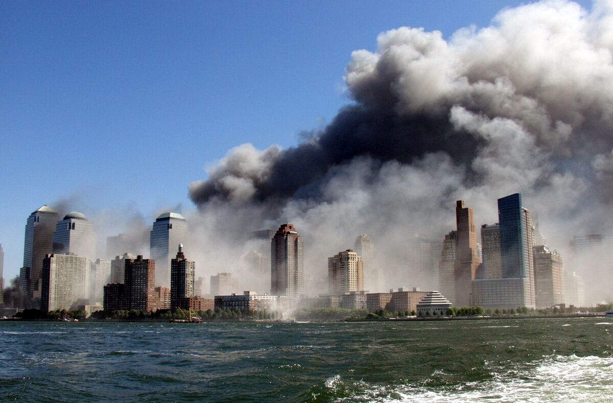 Smoke rises from the World Trade Center Sept. 11, 2001, seen from a tugboat on the Hudson River.  