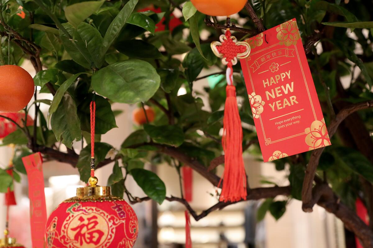 Red envelopes, lanterns and oranges decorate South Coast Plaza's Lunar New Year celebration for the Year of the Tiger.