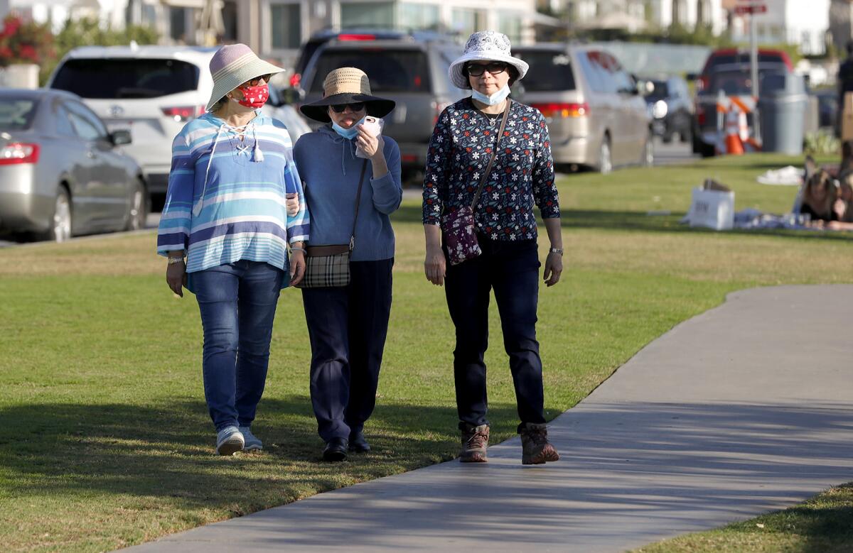 Women go for a walk in Newport Beach.