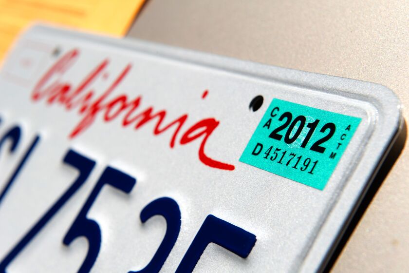 A 2012 registration sticker is displayed on a license plate at the Department of Motor Vehicles (DMV) in Daly City, California, U.S., on Friday, July 1, 2011. Taxes and fees on new cars sold in California will drop an average of $508 per vehicle today after lawmakers deadlocked over extending them, leading the statewide dealers' association to predict a "bounce" in sales. Photographer: David Paul Morris/Bloomberg via Getty Images