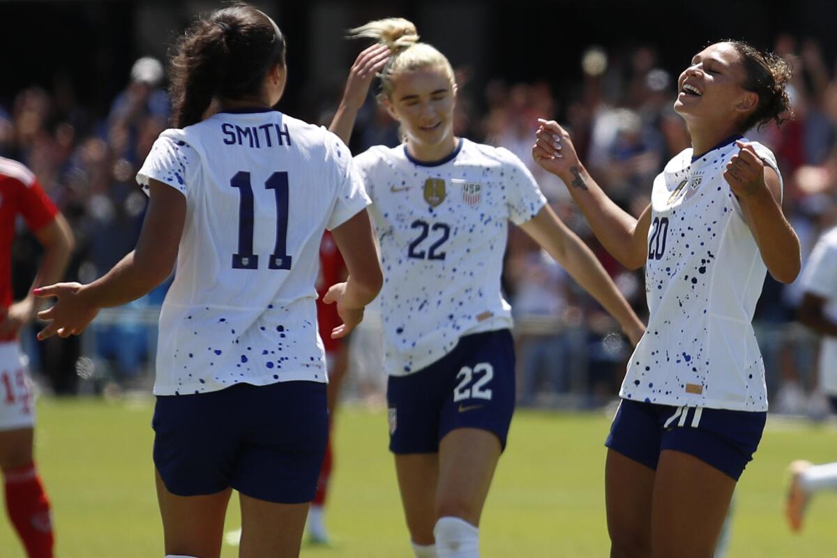 Sophia Smith, left, Kristie Mewis, center and Trinity Rodman celebrate after the U.S. scored a goal earlier this month.