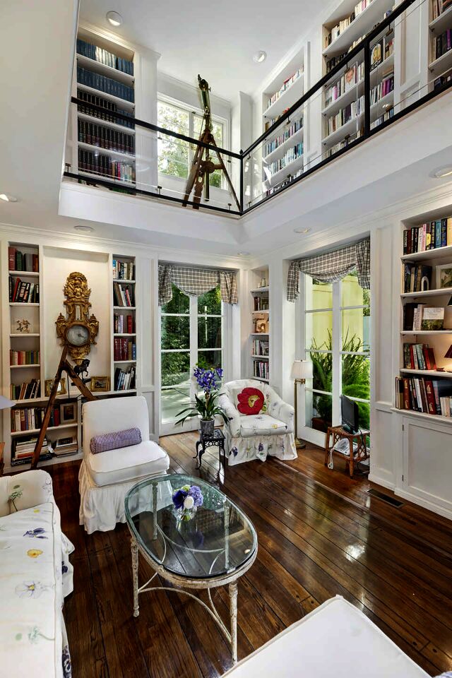 A two-story library with walls of built-ins sits off the rotunda entry.