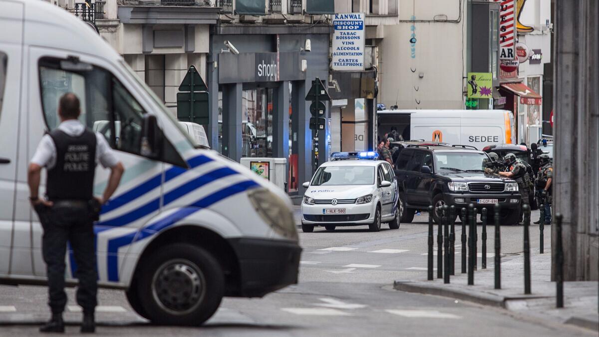 A police officer takes part in a Brussels operation to surround a suspect July 20.