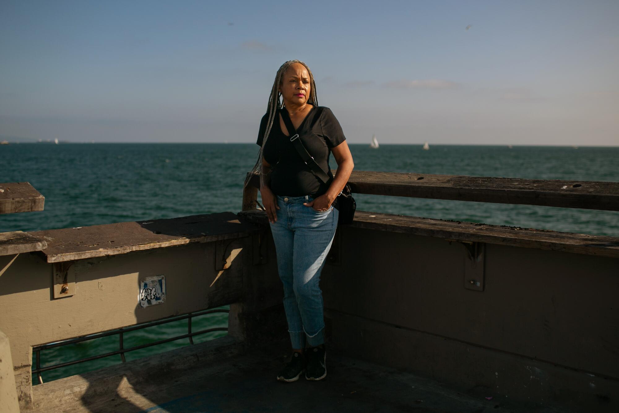 Deneen Vaughn stands on the Venice Beach pier at the location where she and her family scattered the ashes of her son Chris