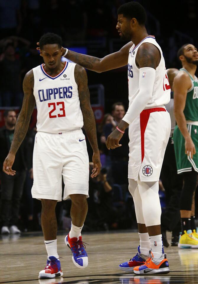 Clippers guard Lou Williams is congratulated by Paul George after hitting a three-pointer against the Celtics during the fourth quarter of a game Nov. 20 at Staples Center.