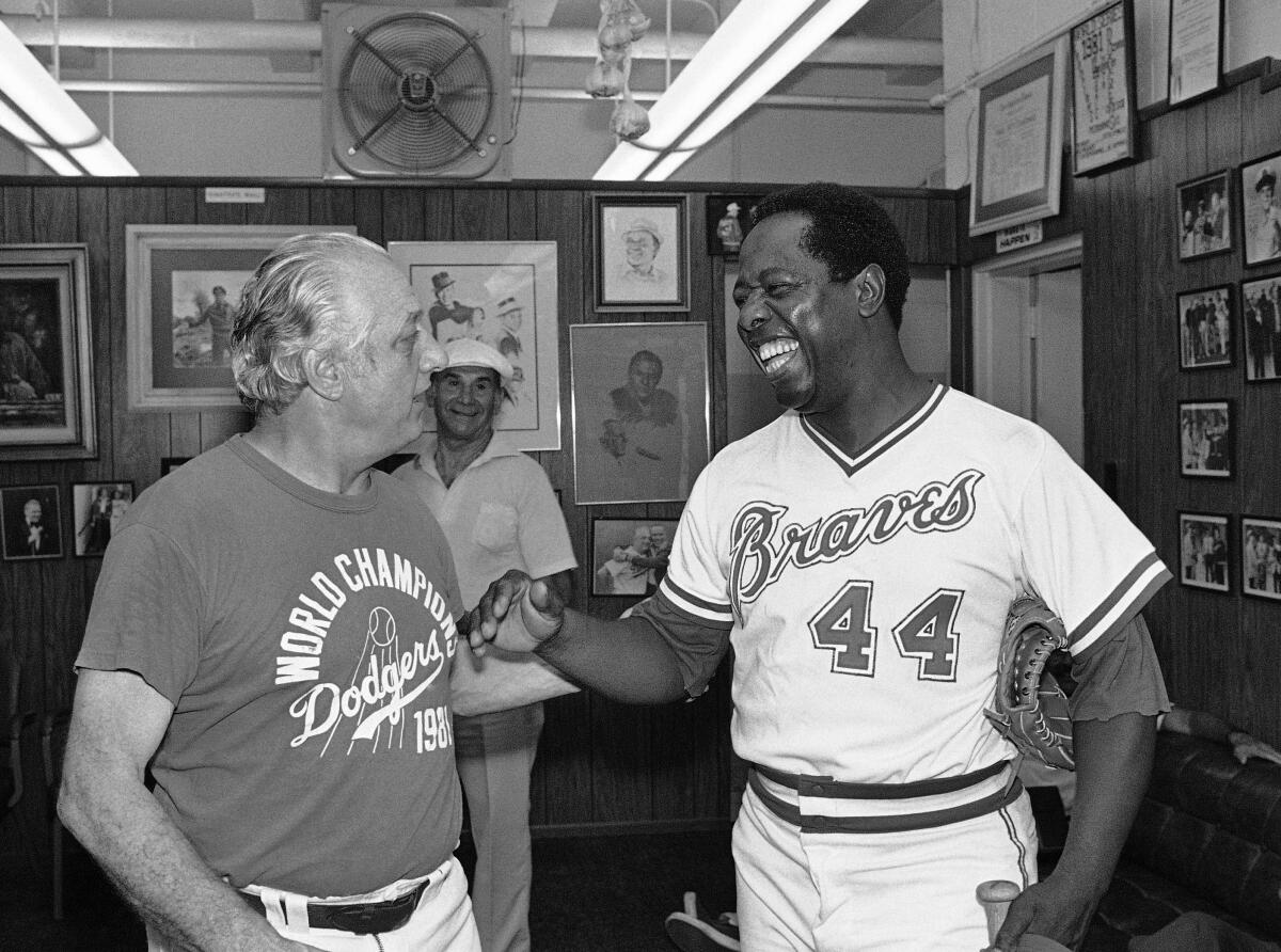 Hank Aaron, right, jokes with Dodgers manager Tommy Lasorda.