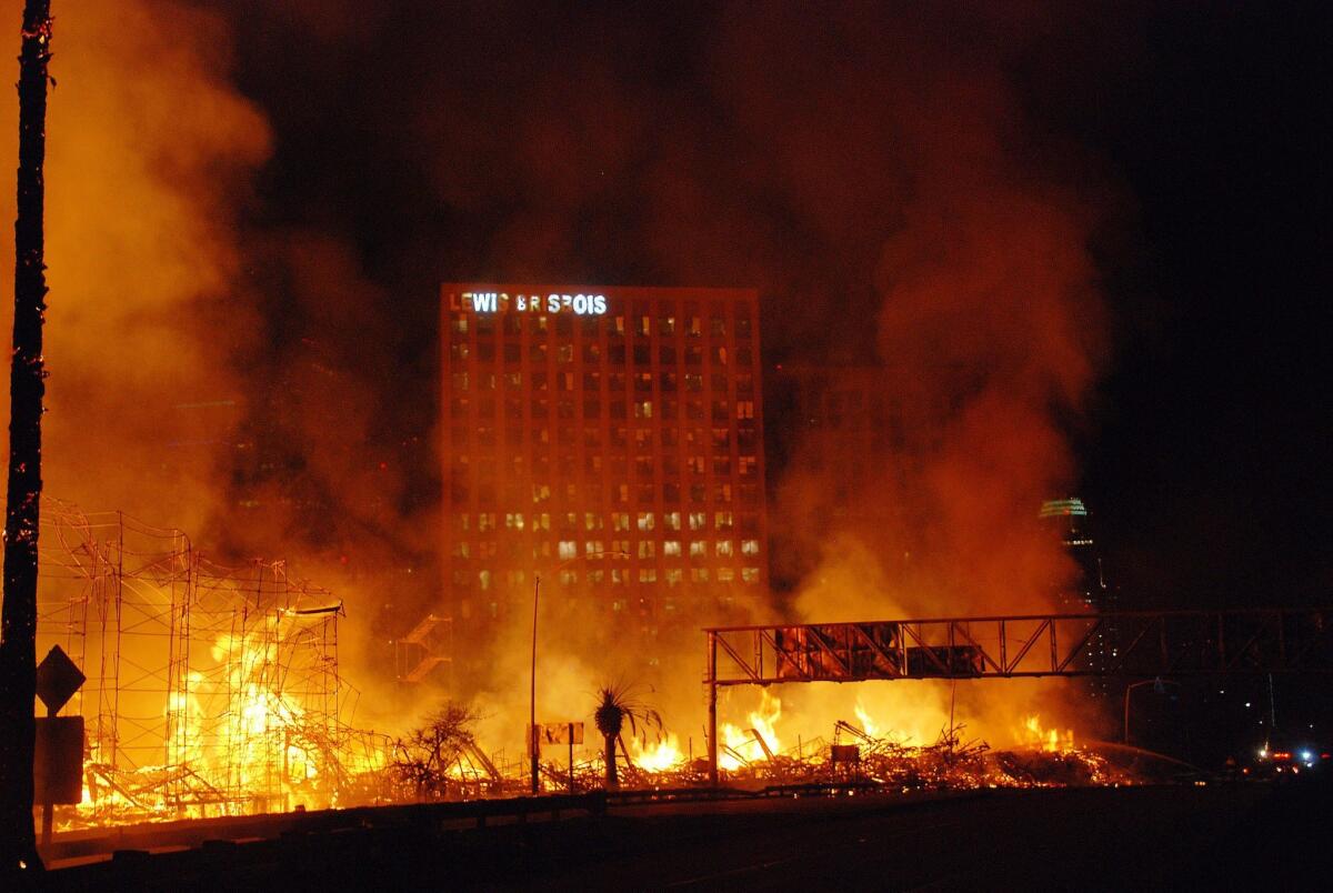 Los Angeles firefighters work to control a massive fire as it destroys the DaVinci apartment complex under construction in downtown Los Angeles.
