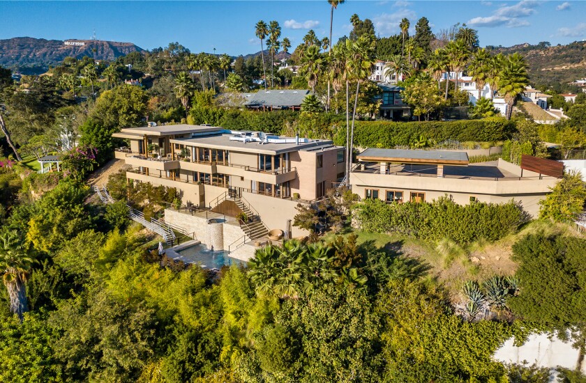 The hillside home includes three levels of decks, balconies and patios, as well as a swimming pool and spa.