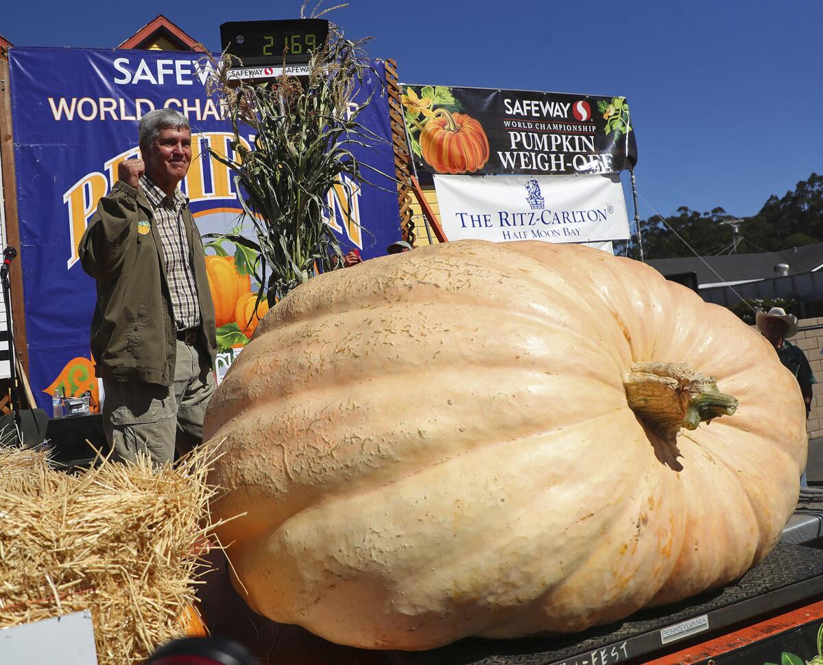 Steve Daletas of Pleasant Hill, Ore., celebrates his first place win in the Pumpkin Weigh-Off in 2018 in Half Moon Bay. The giant pumpkin weighed 2,170 pounds