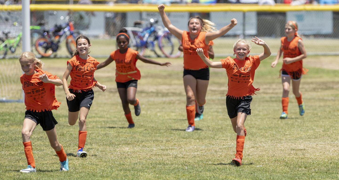 Davis's girlsÕ fifth- and sixth-grade team celebrate a win over Sonora in a Bronze Division quarterfinal match at the Daily Pilot Cup on Saturday , June 2.