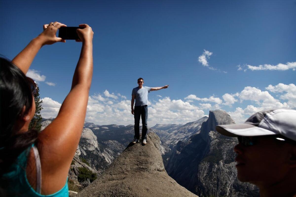 A friend snaps a picture of Norm Zalog in Yosemite National Park as the Rim fire burns about 25 miles away.