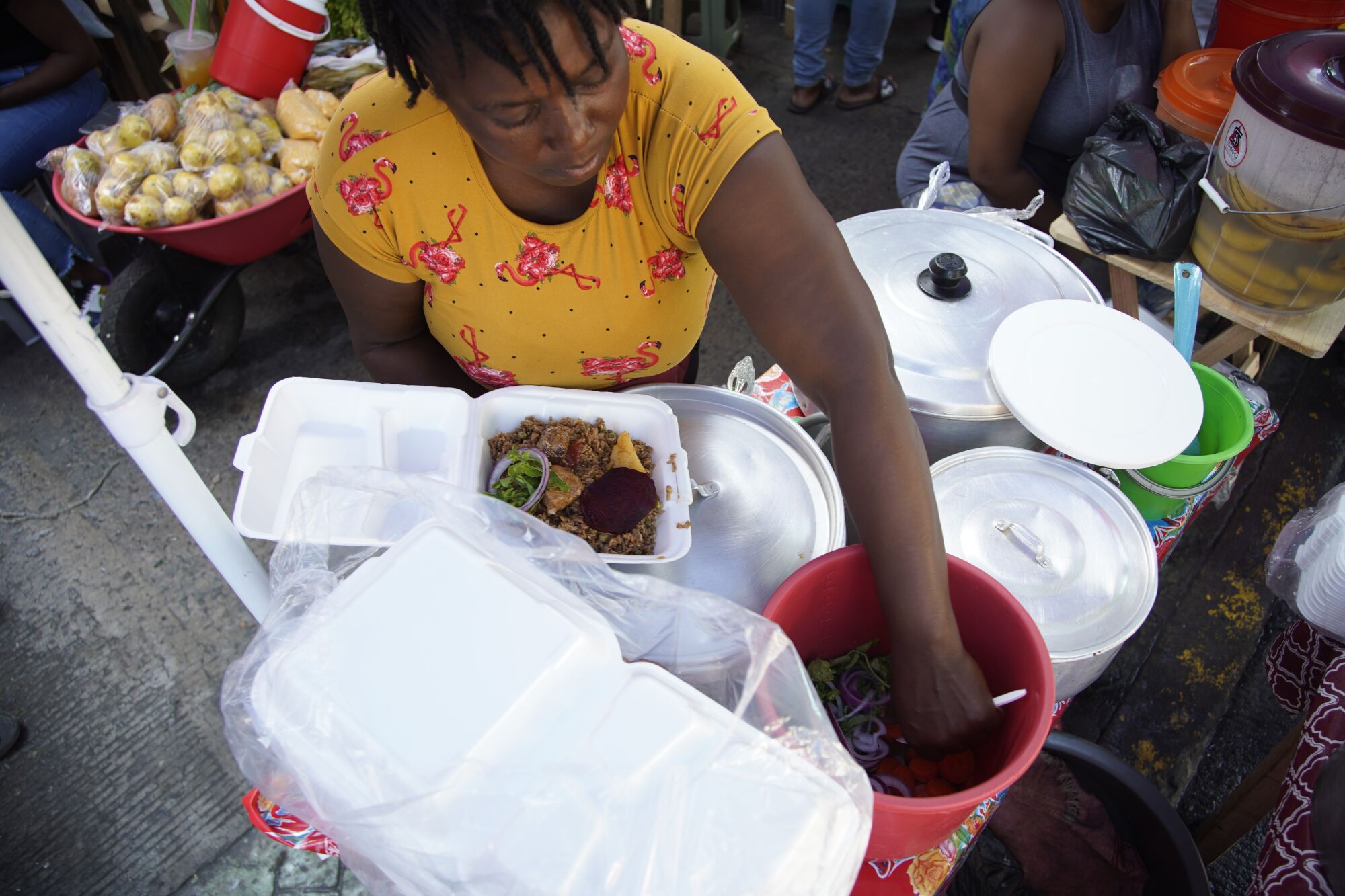 A woman sells Haitian food at a street market in downtown Tapachula