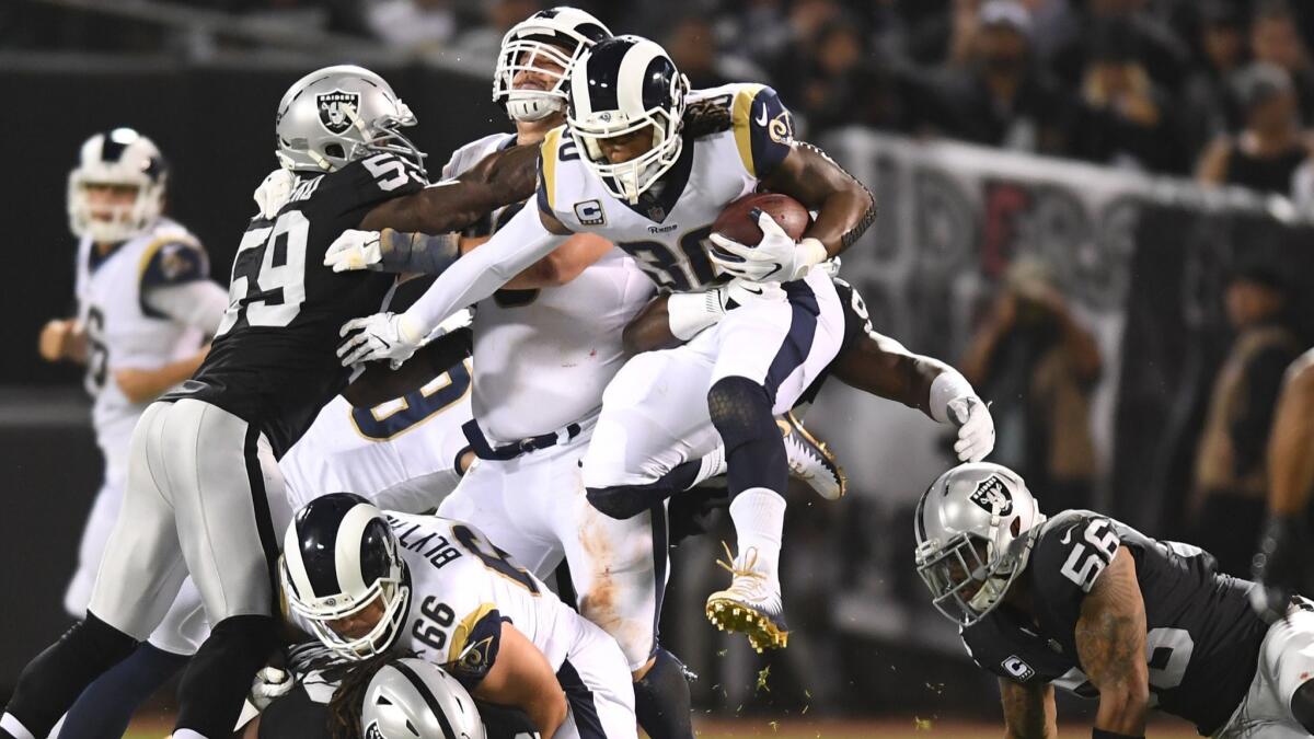 Rams running back Todd Gurley leaps over the defense to pick up yards against Oakland.
