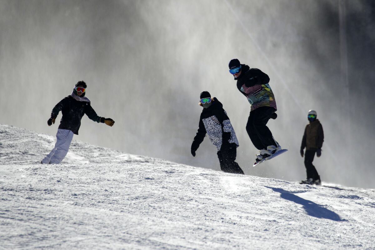 Skiers and snowboarders enjoy fresh snow