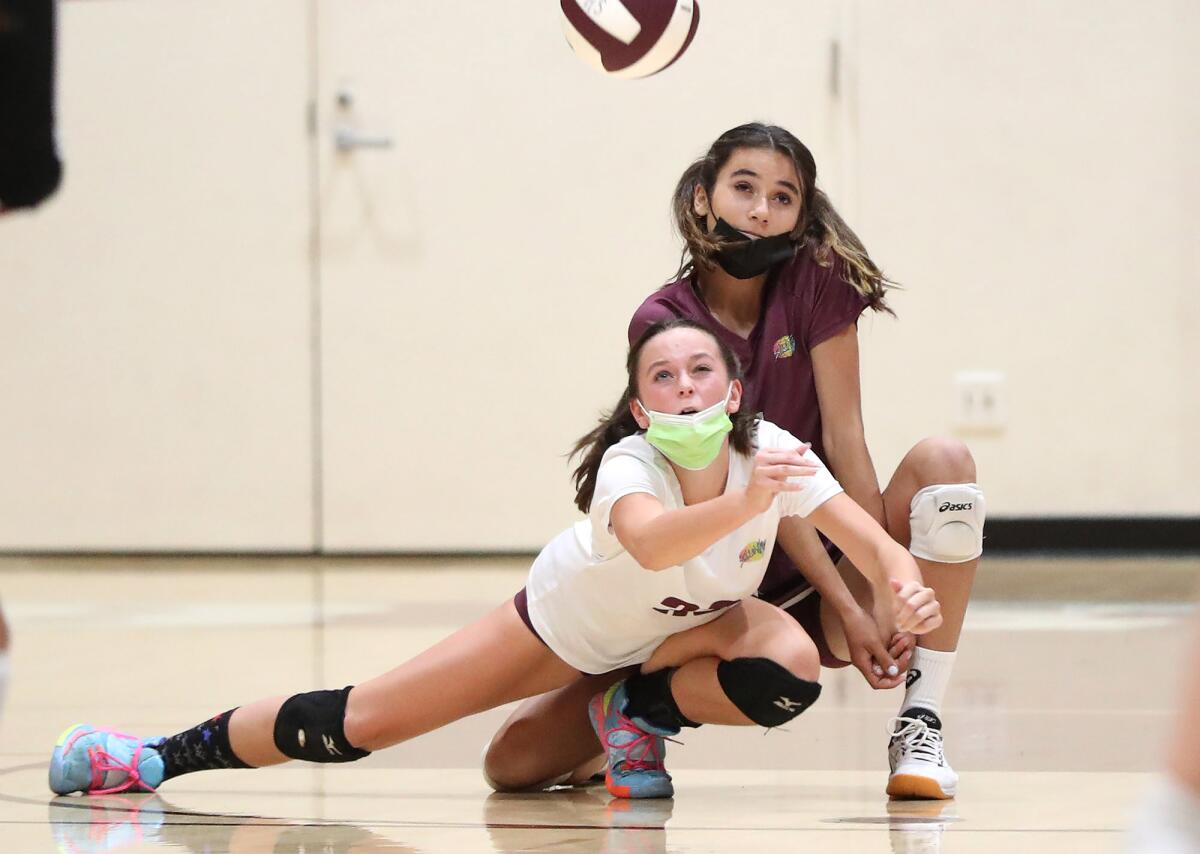 Laguna's Dempsey Sadler (33) dives to save a ball during a long rally as Kyra Zaengle backs her up.