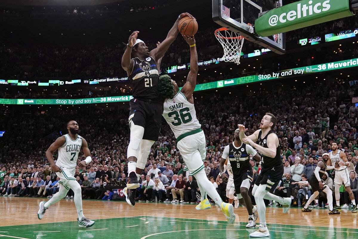 Milwaukee Bucks guard Jrue Holiday blocks a shot by Boston Celtics guard Marcus Smart in the final seconds of play.