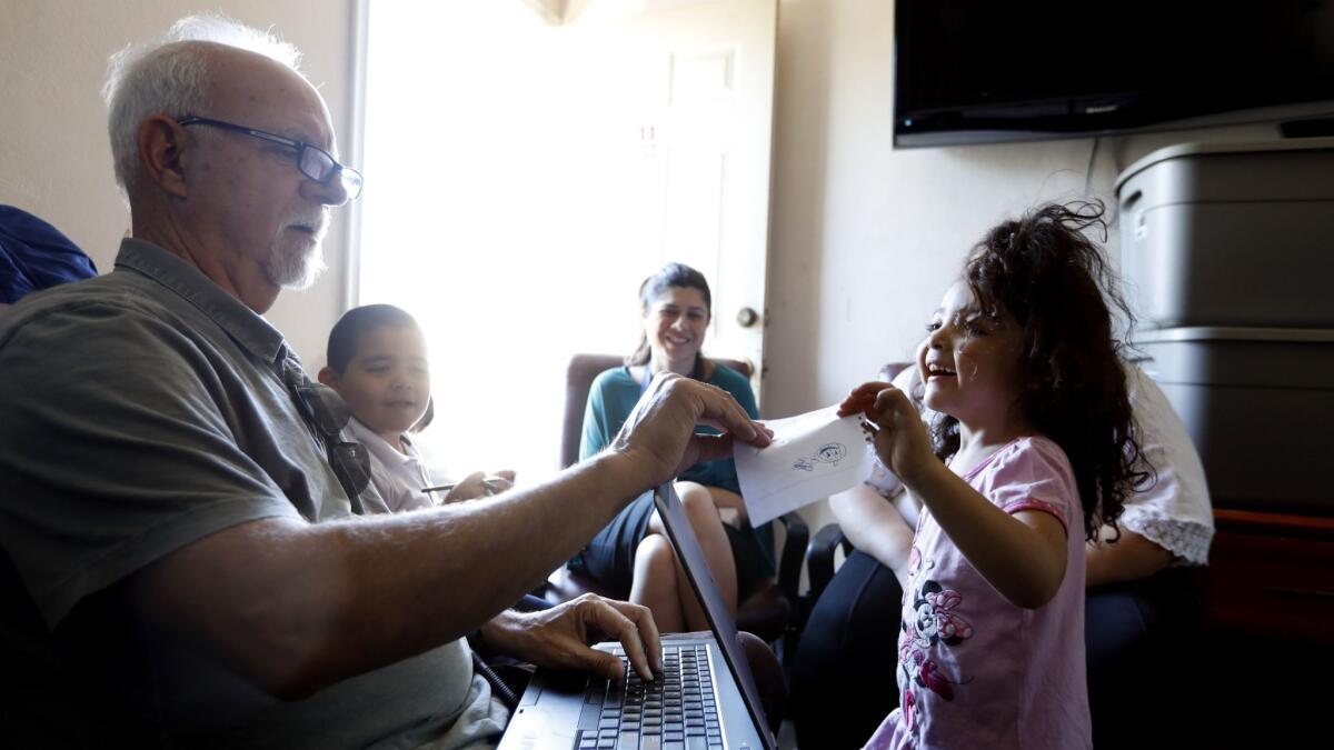 Los Angeles Times Columnist Steve Lopez interviews a family in a motel room in Pacoima.