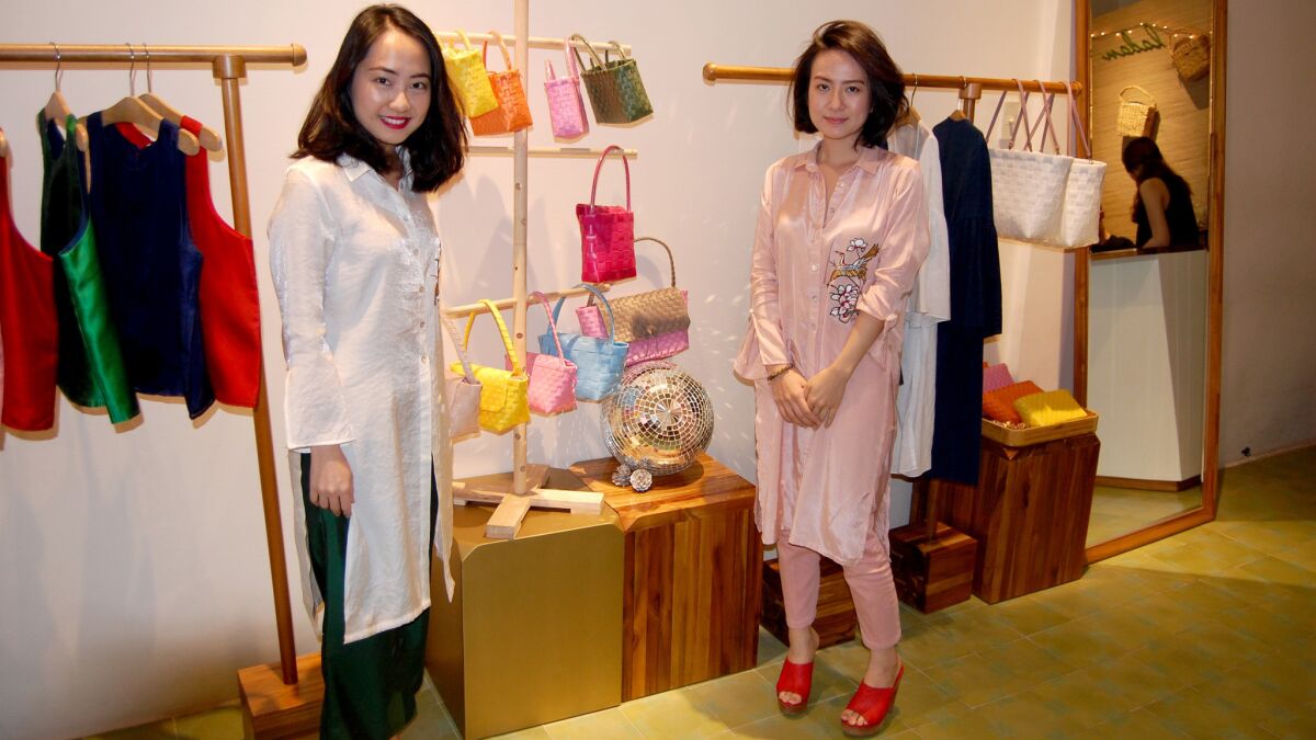 Thao Dao and Anna Phan returned from college in the U.S. to open Ladan, a company that sells modern Vietnamese clothes and accessories to young people. (L.R. Meyers)