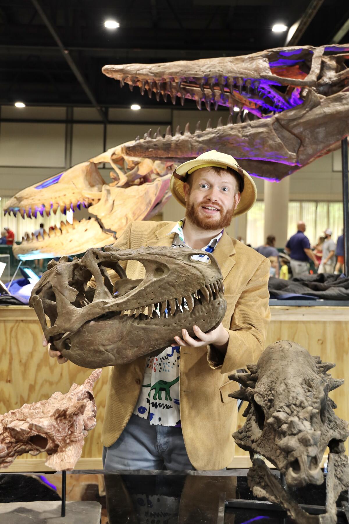 Jurassic Quest dinosaur trainer Prehistoric Nick holds up a dinosaur skull.