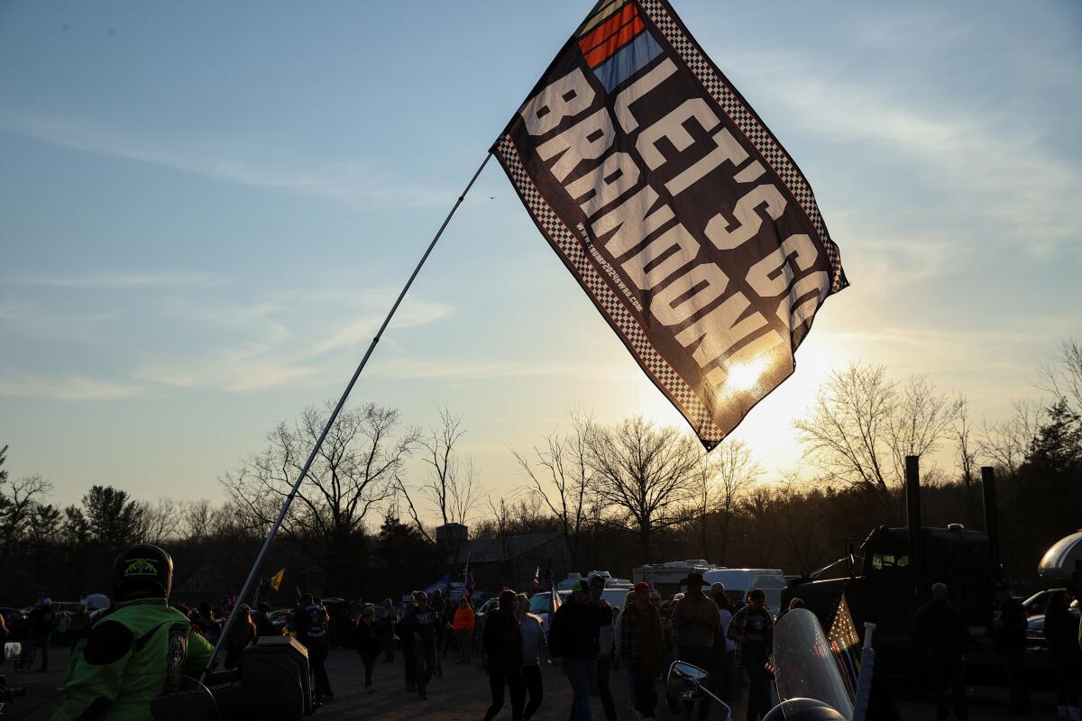  A motorcyclist holds a flag that says "Let's go Brandon" 